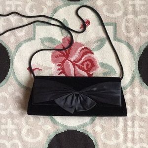 Black velvet clutch with satin bow and cord strap